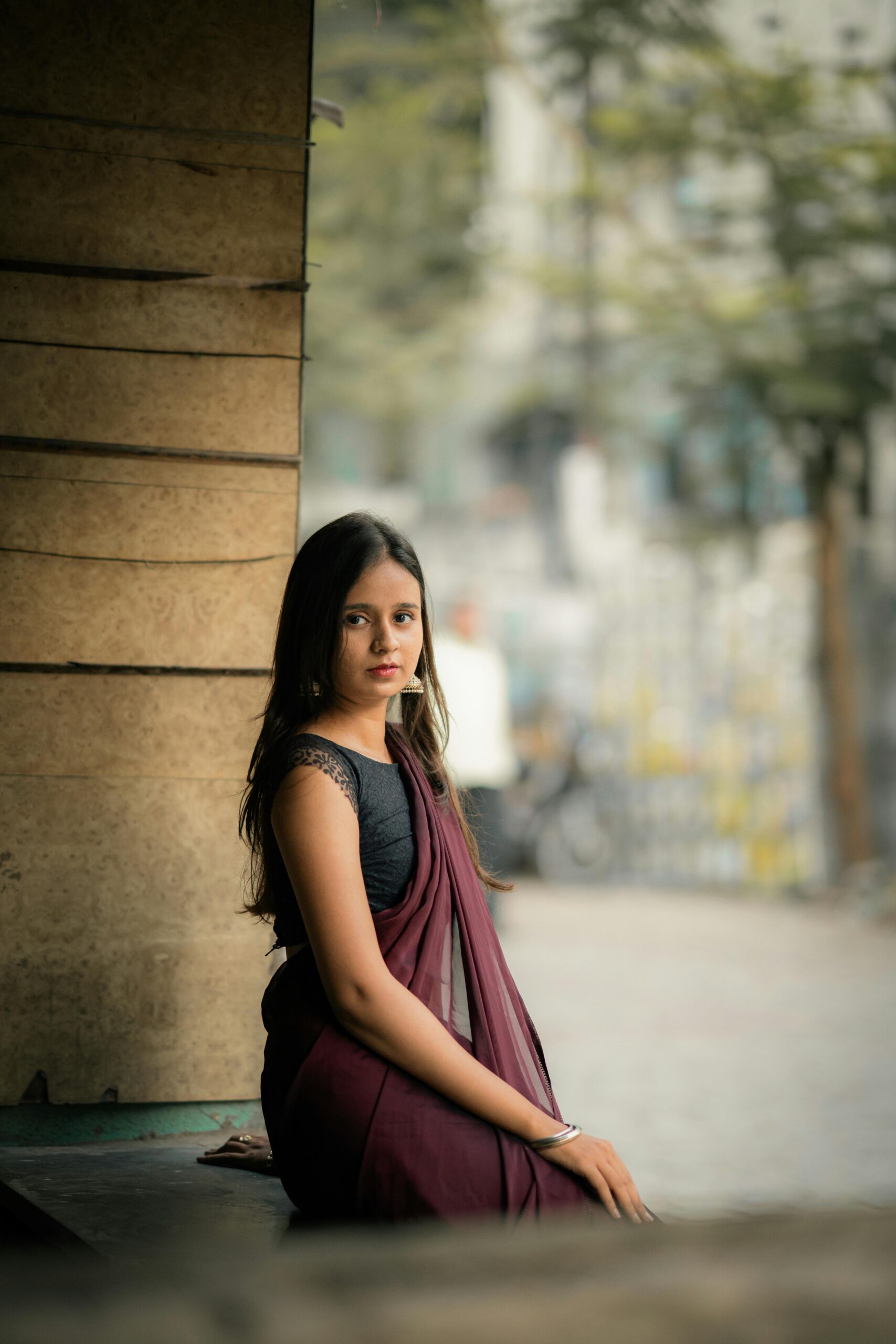A captivating outdoor portrait of a young woman wearing a traditional Indian saree.
